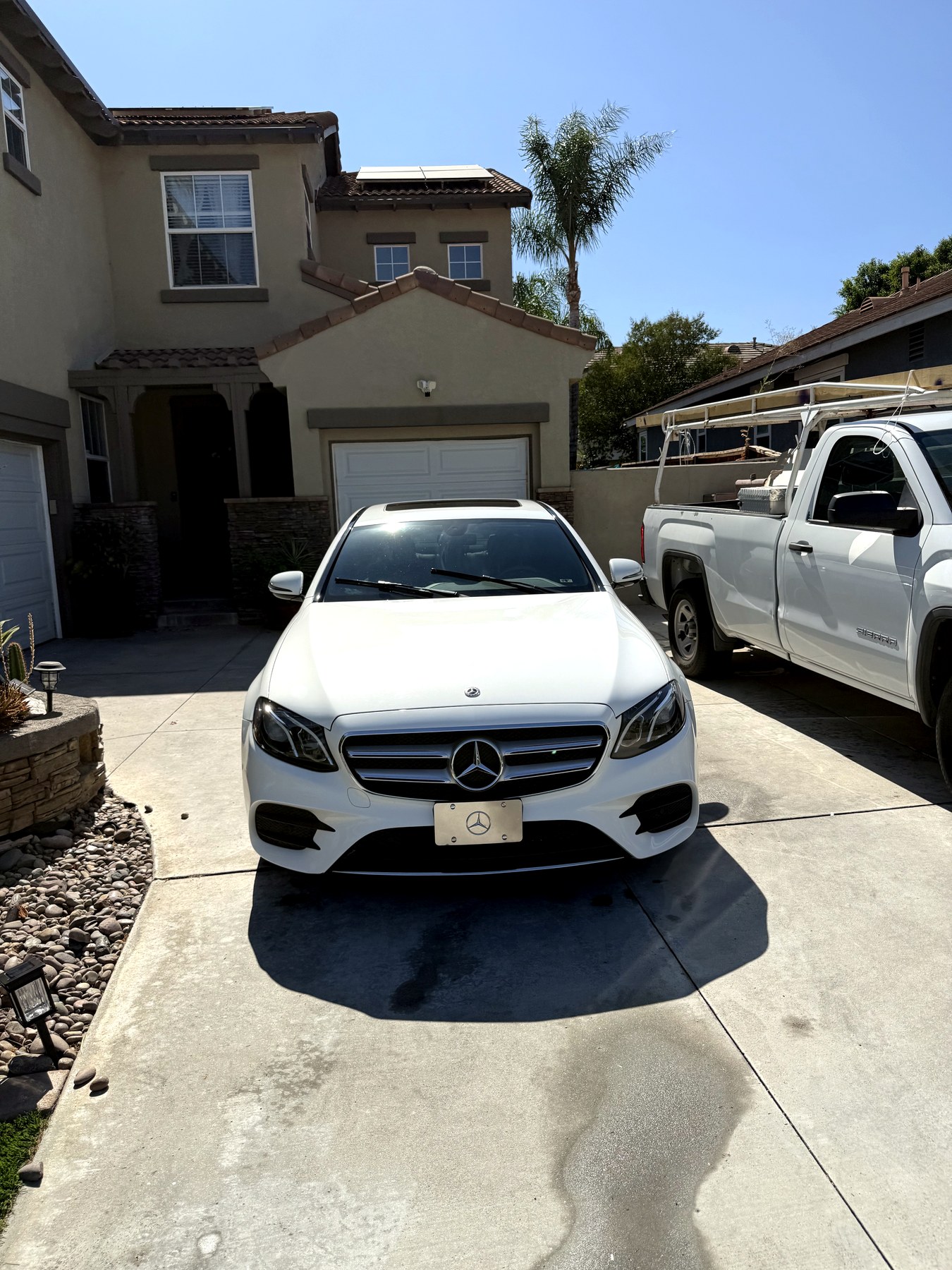 White Mercedes E-Class detailed in a residential driveway